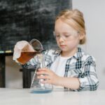 child performing science experiment
