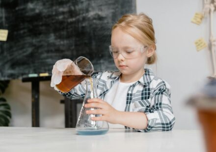 child performing science experiment