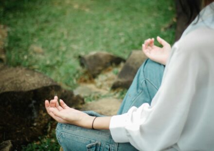 person meditating outdoors with phone off