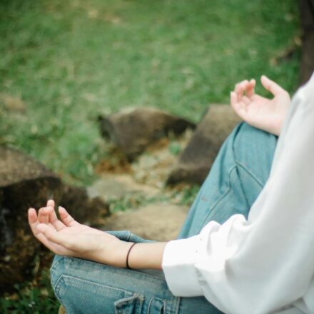 person meditating outdoors with phone off