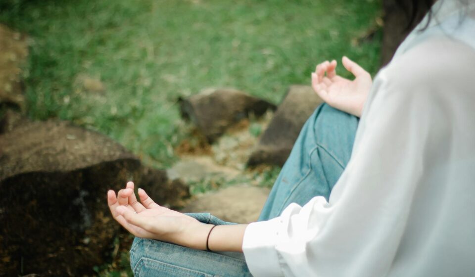person meditating outdoors with phone off