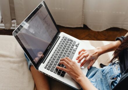 person writing enthusiastically on laptop