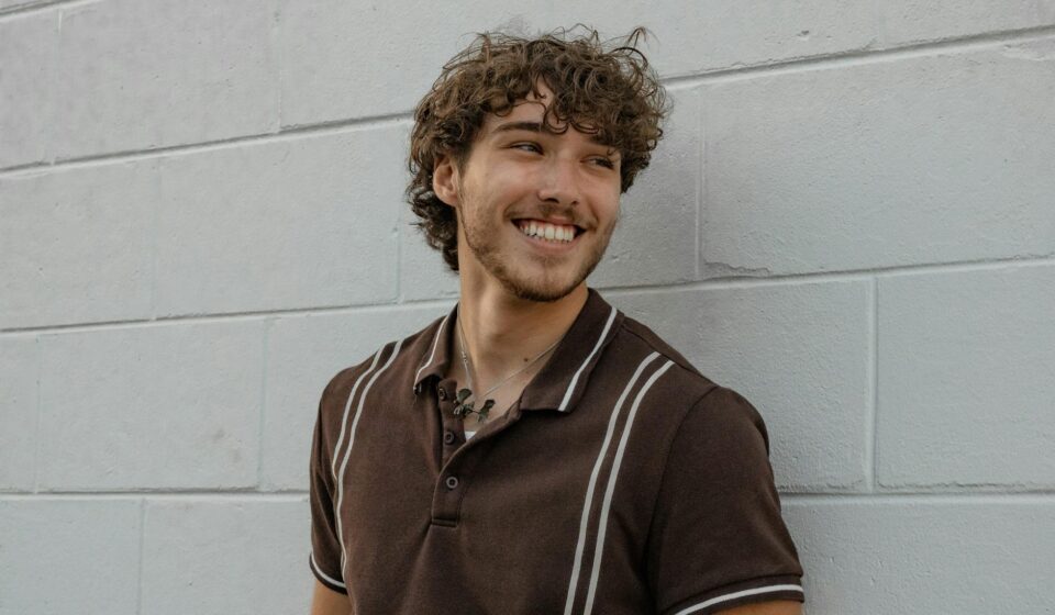 young pedro pascal smiling