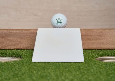 beginner golfer with training aid